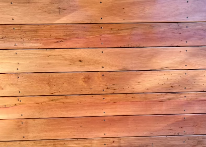 Wooden planks with a gradient of brown tones against a dark background