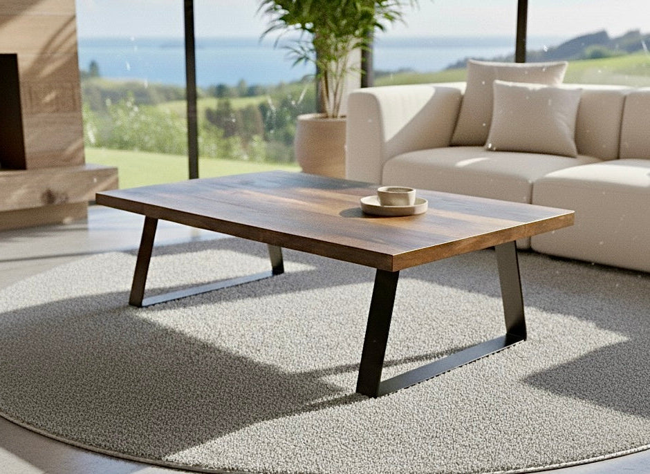 Modern coffee table in a living room with a view of greenery outside
