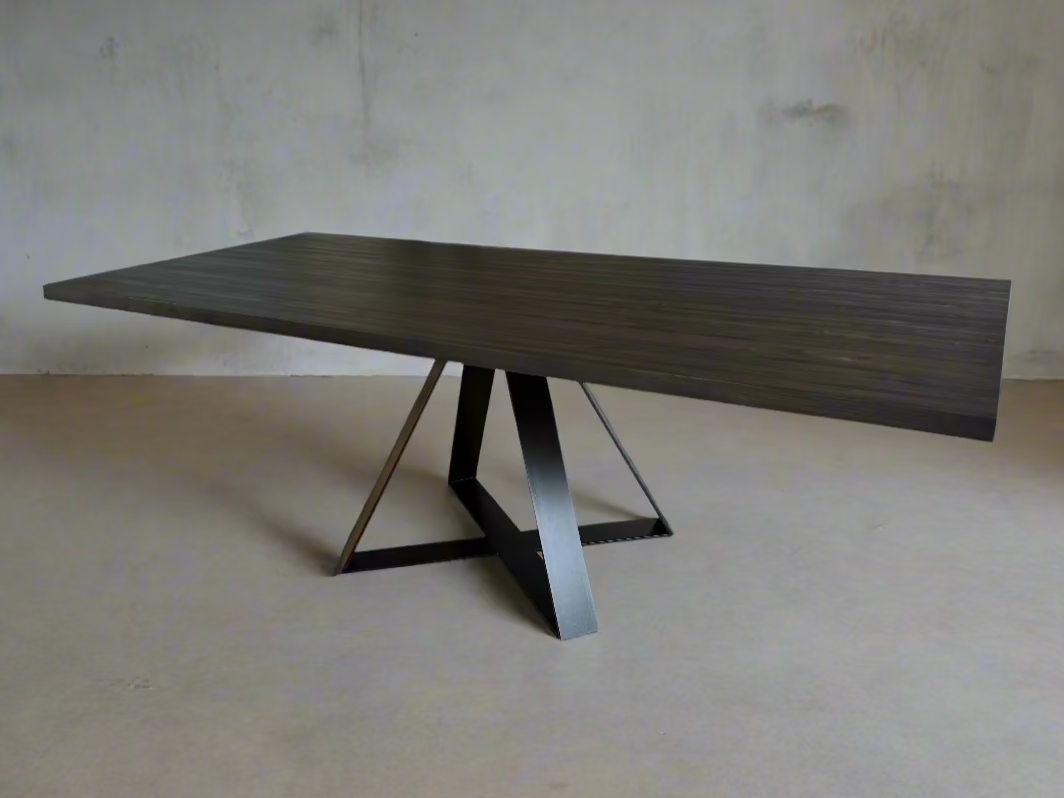 Modern dining table with dark beech timber top and sculptural black steel Crossroads base, displayed in a minimal interior setting.