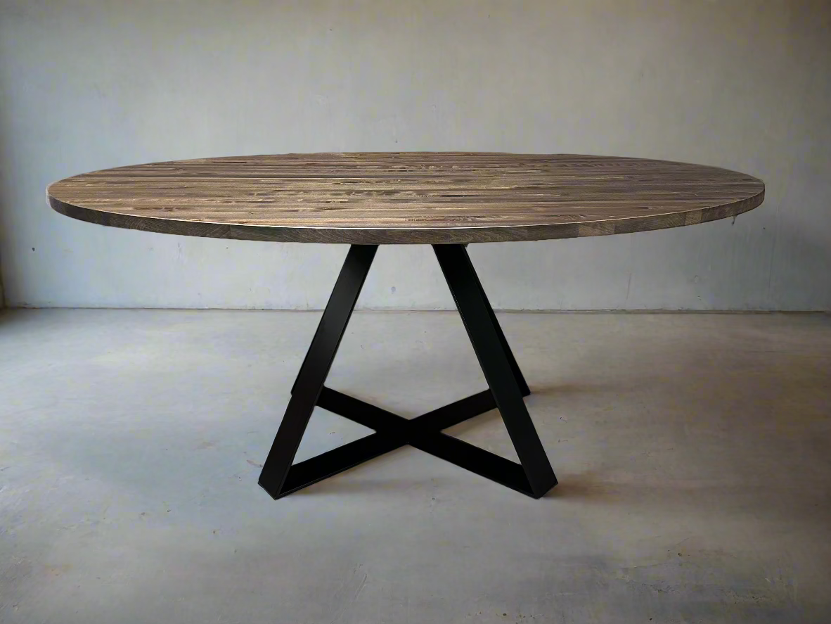 Round wooden table with black metal legs on a plain floor and wall background