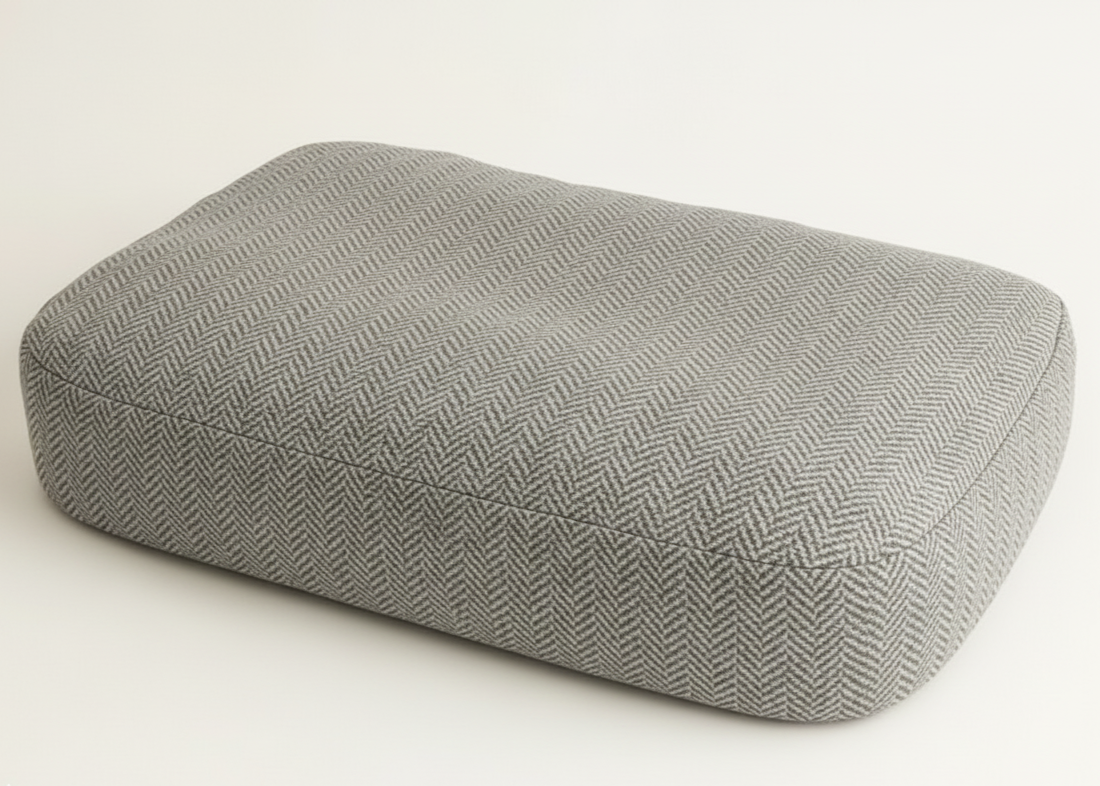 Gray textured rectangular cushion on a white background