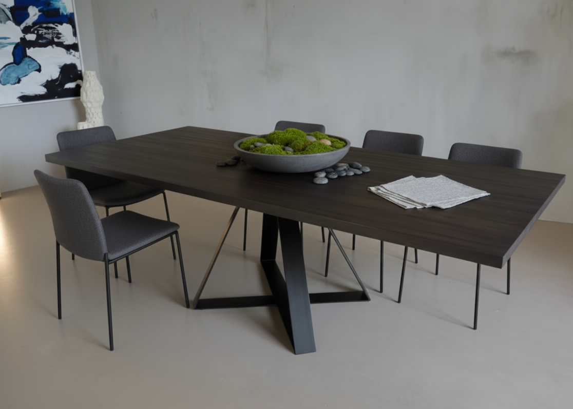 Dining table with chairs and a bowl of fruit in a minimalistic room.