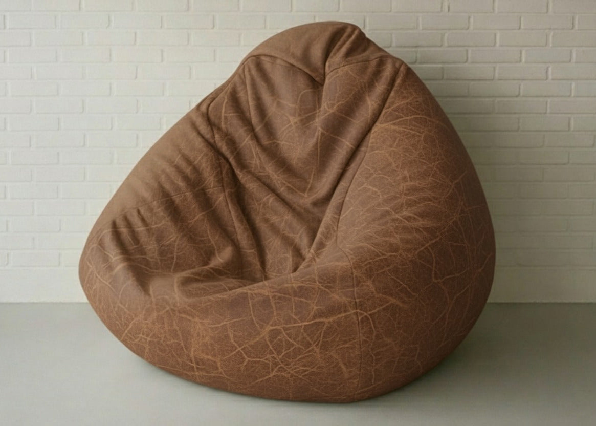 Brown bean bag chair against a white brick wall.
