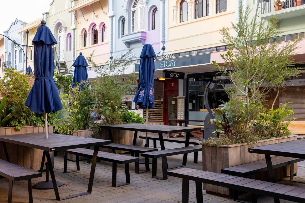 Exterior timber tables and benches outside Gin Gin on New Regent Street
