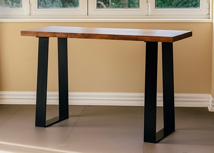 Rectangular console table with brown top and black trapezoid legs