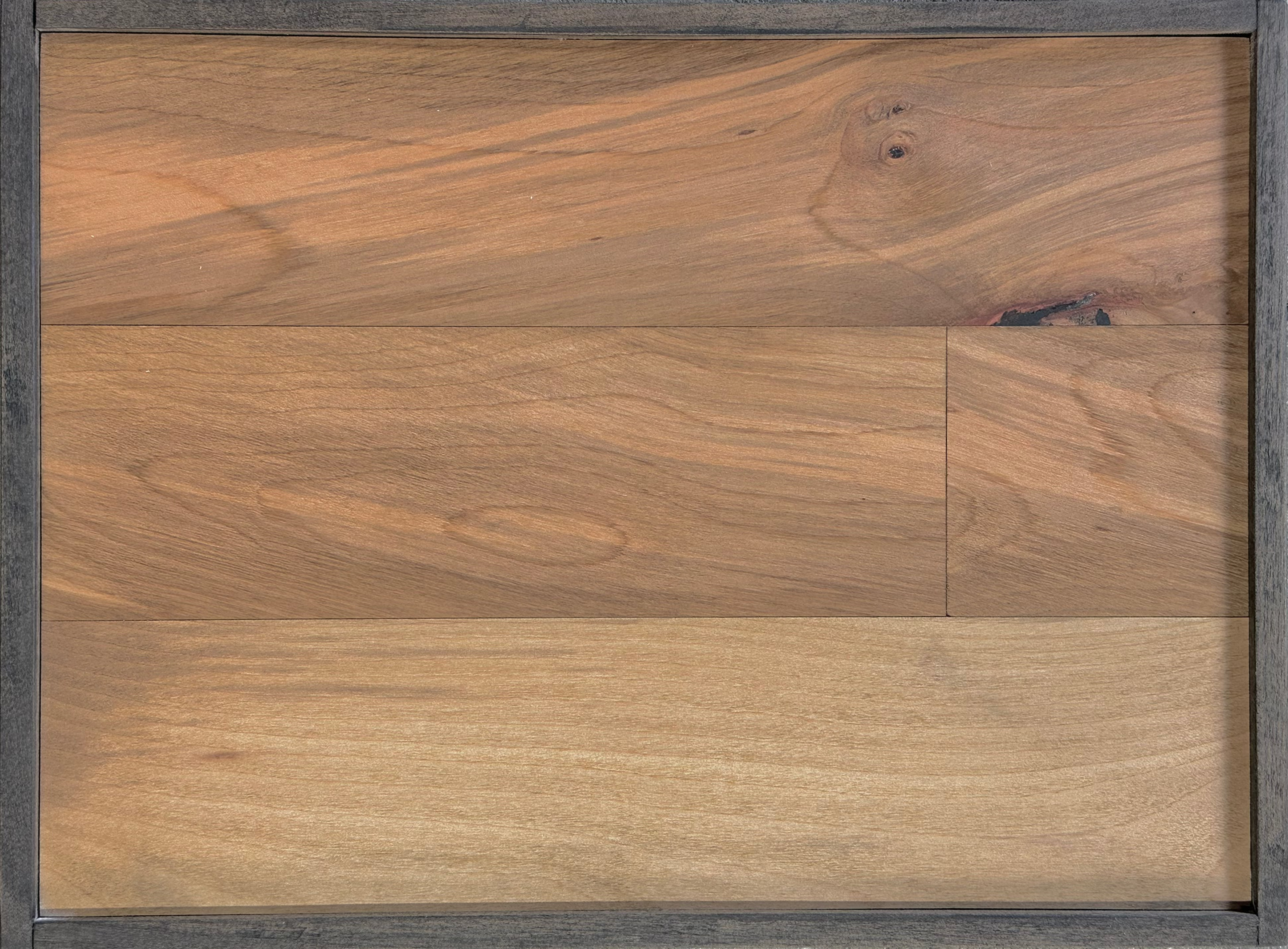 Close-up of brown wood-grain flooring with dark seams