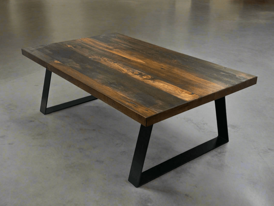 Rectangular coffee table with dark brown top and black trapezoid legs