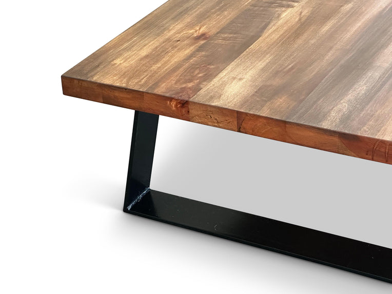 Close-up of a wood-grain tabletop with a black rectangular base