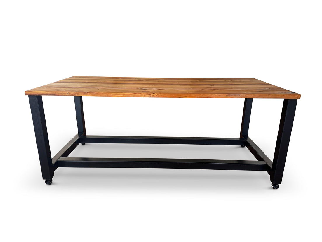Brown rectangular tabletop on black frame legs with small wheels