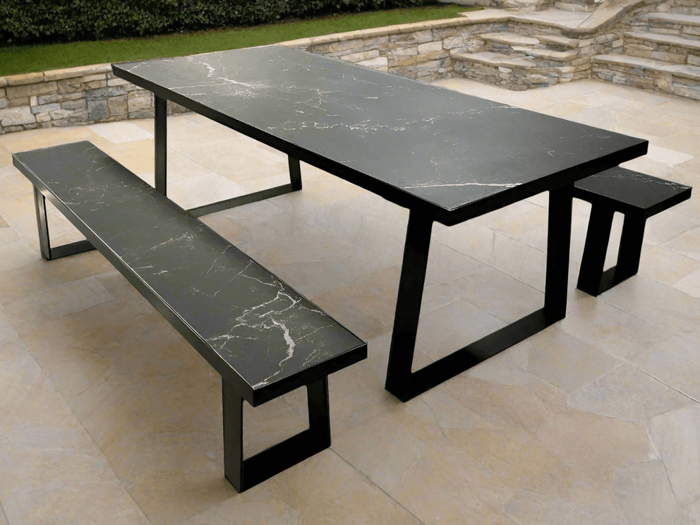 Black rectangular outdoor dining table with benches on a patio