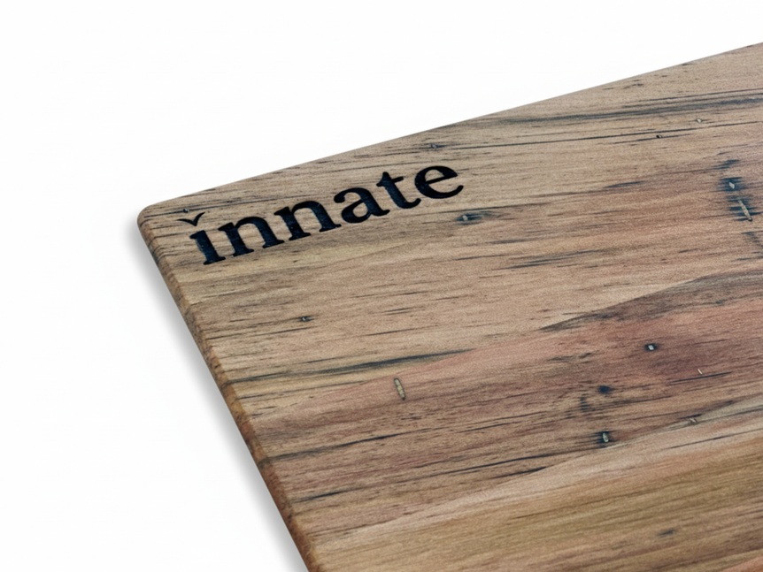 Close-up of wood-grain board corner with Innate logo