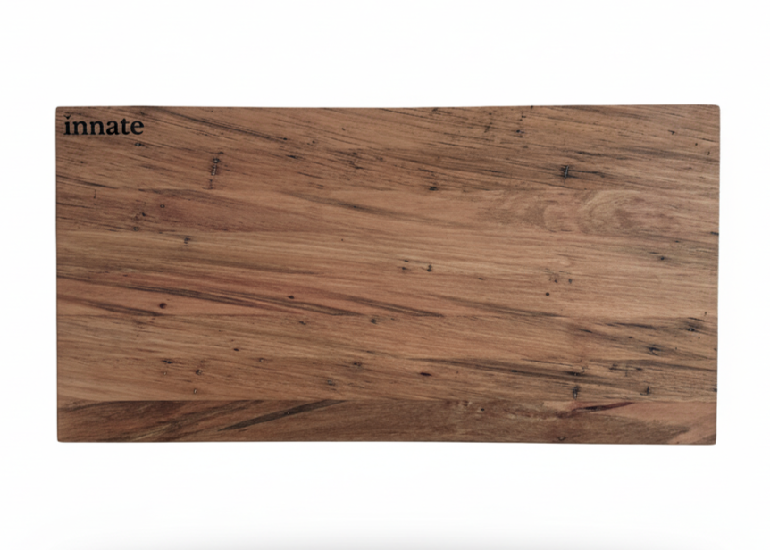 Rectangular wood-grain board with Innate logo on white background