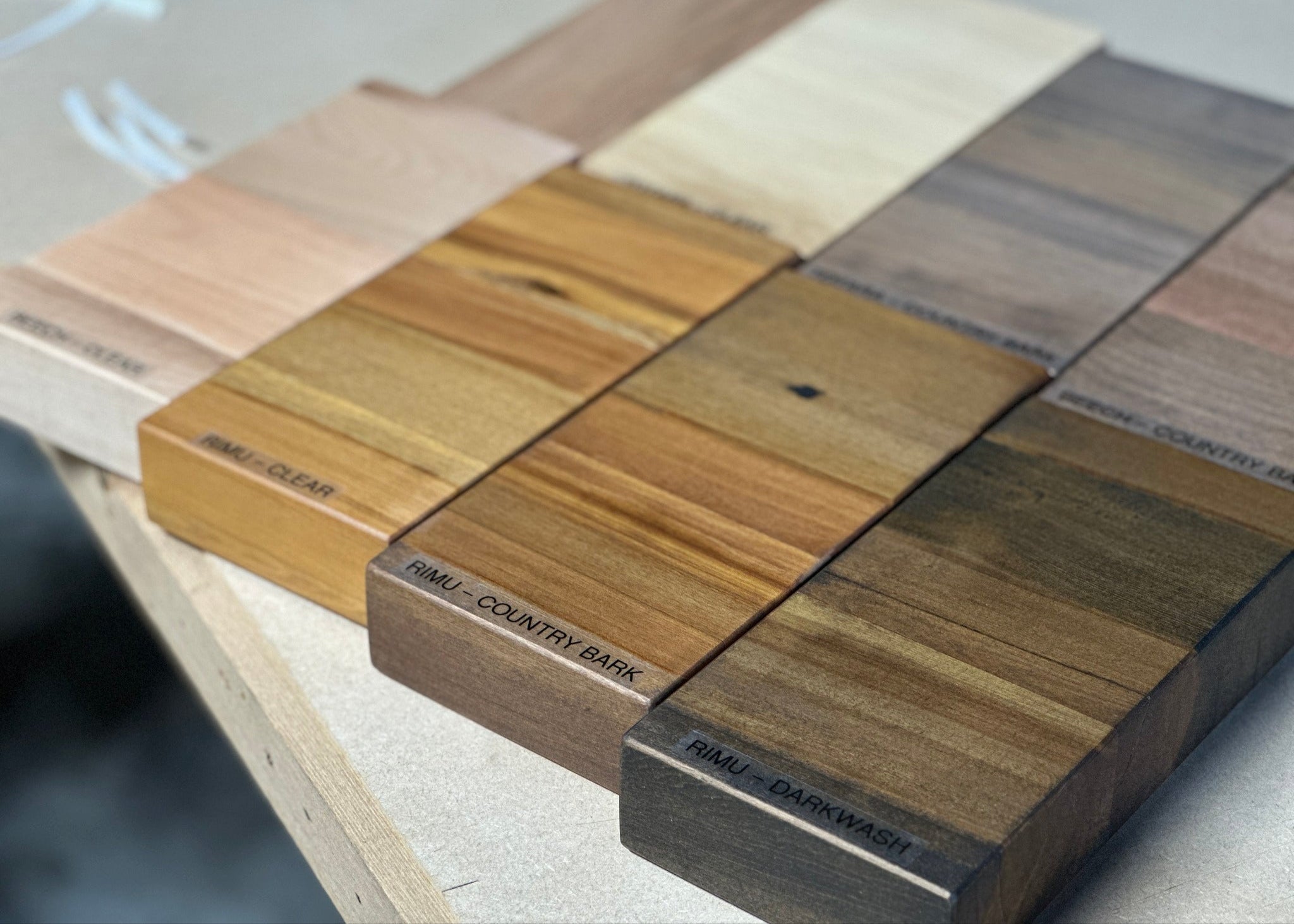 Timber sample blocks with different finishes on a light surface
