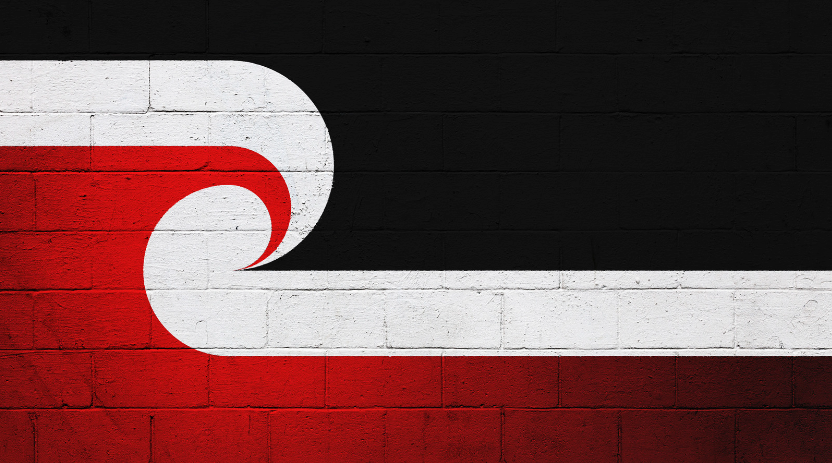 Black, red and white painted brick wall with a large curved white symbol