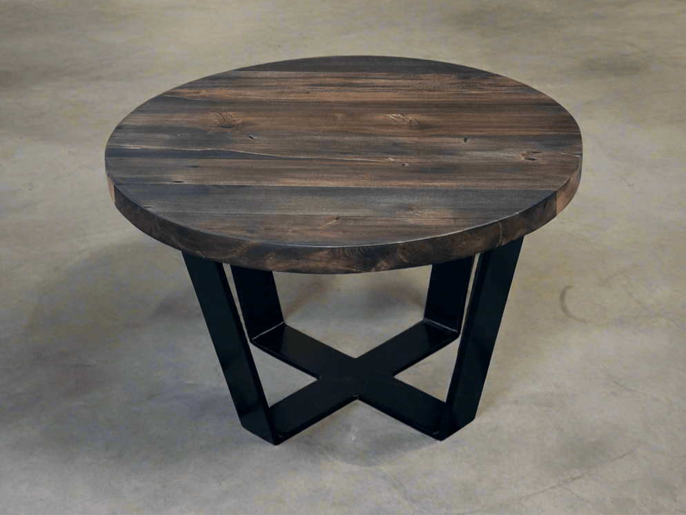 Round coffee table with dark top and black geometric base