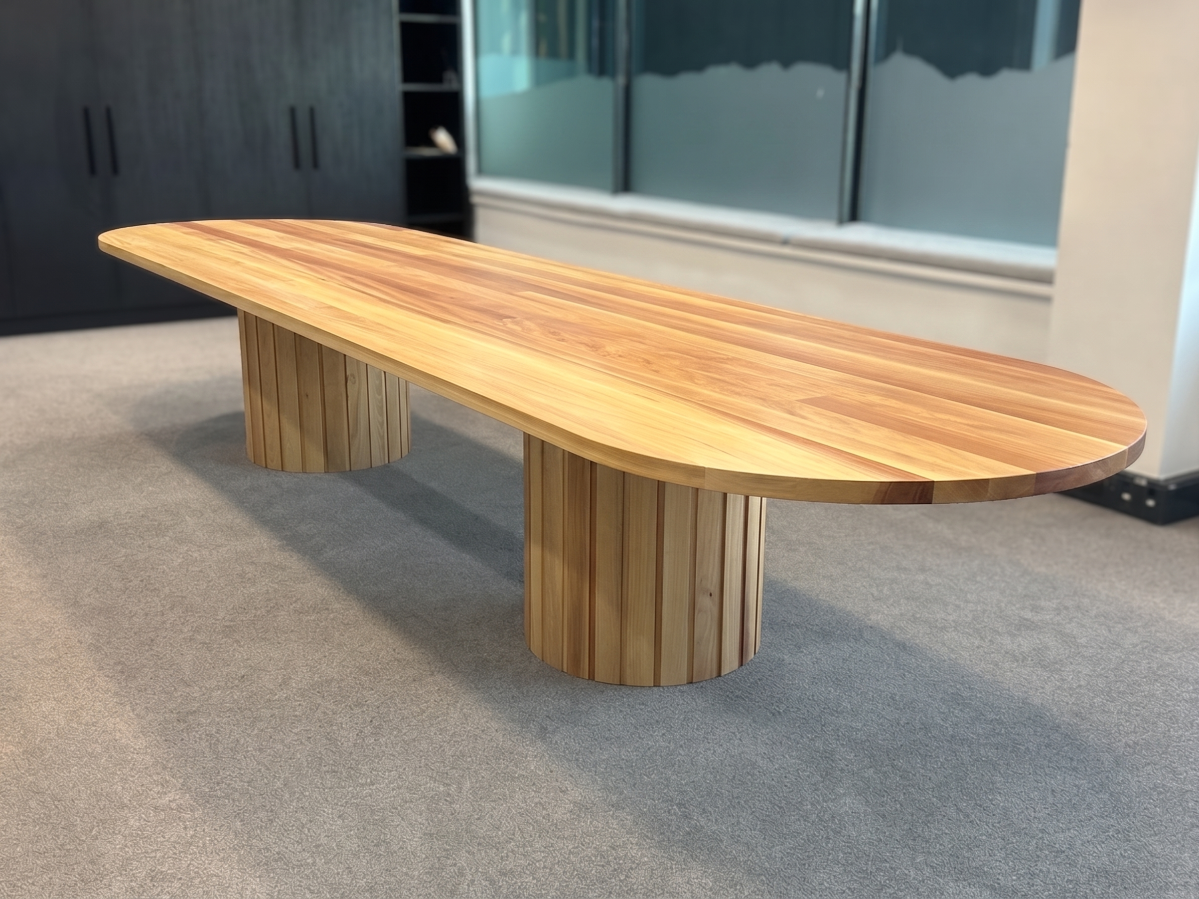 A 4.5m custom Tōtara boardroom table with two slatted cylindrical Tōtara pedestals, made by Innate Furniture in Christchurch.
