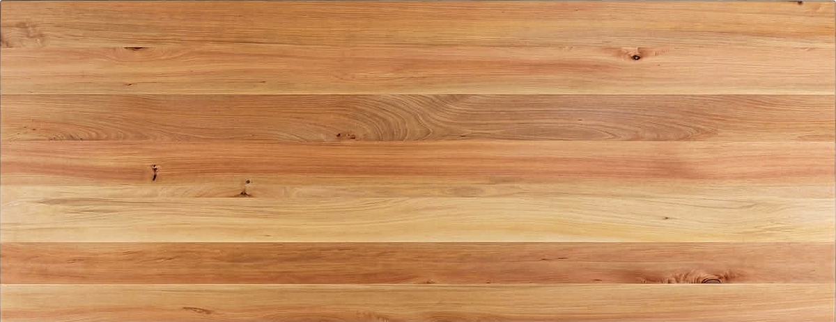 Close-up of a finished Northland tōtara tabletop showing honey timber, pink-tan stripes and a small natural knot