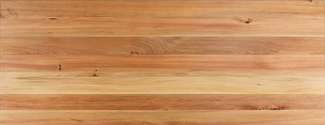 Close-up of a finished Northland Tōtara tabletop showing pale honey timber with pink-tan stripes across the boards and a small natural knot.