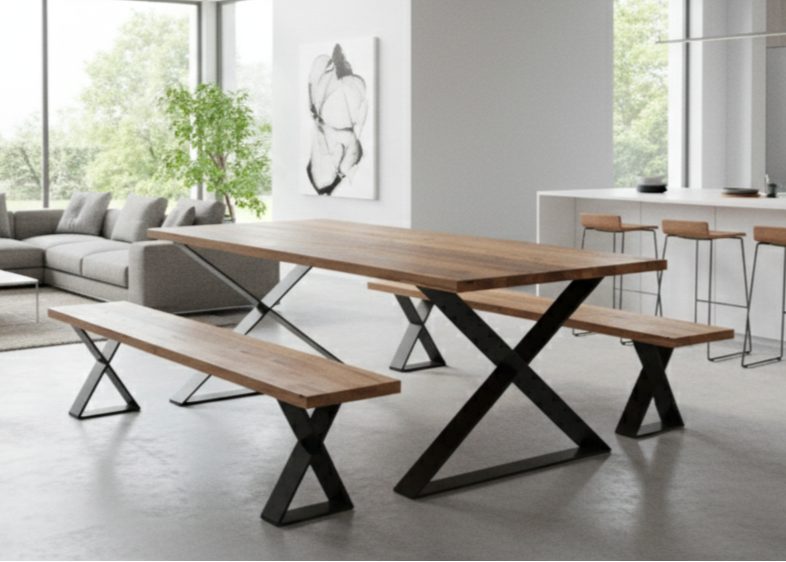 A large dining table featuring crossed X-shaped leg frames at each end and a thick wooden top, creating a modern architectural look in a spacious dining room.