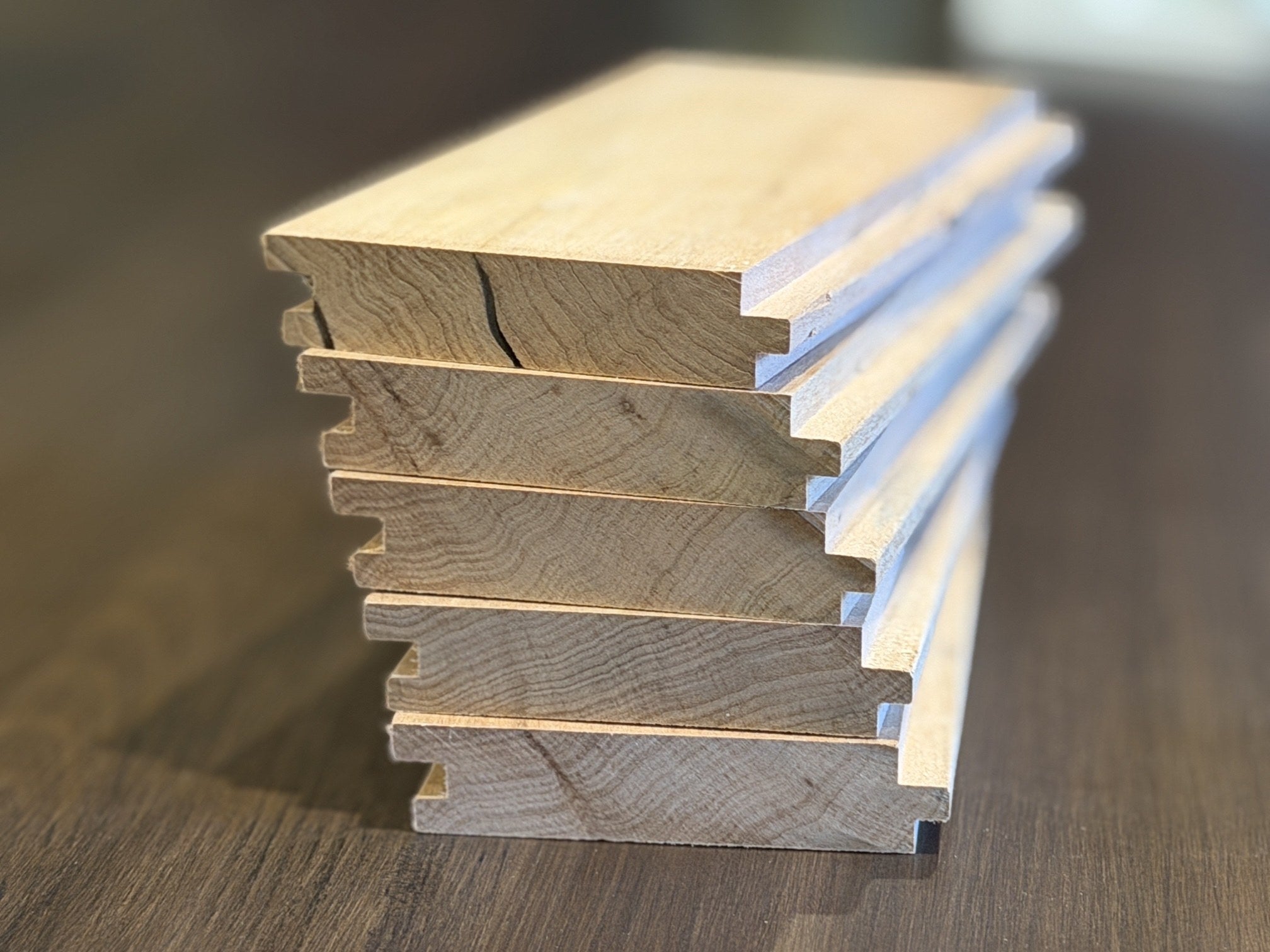 Stack of uncoated silver beech tongue and groove floorboards showing the profile