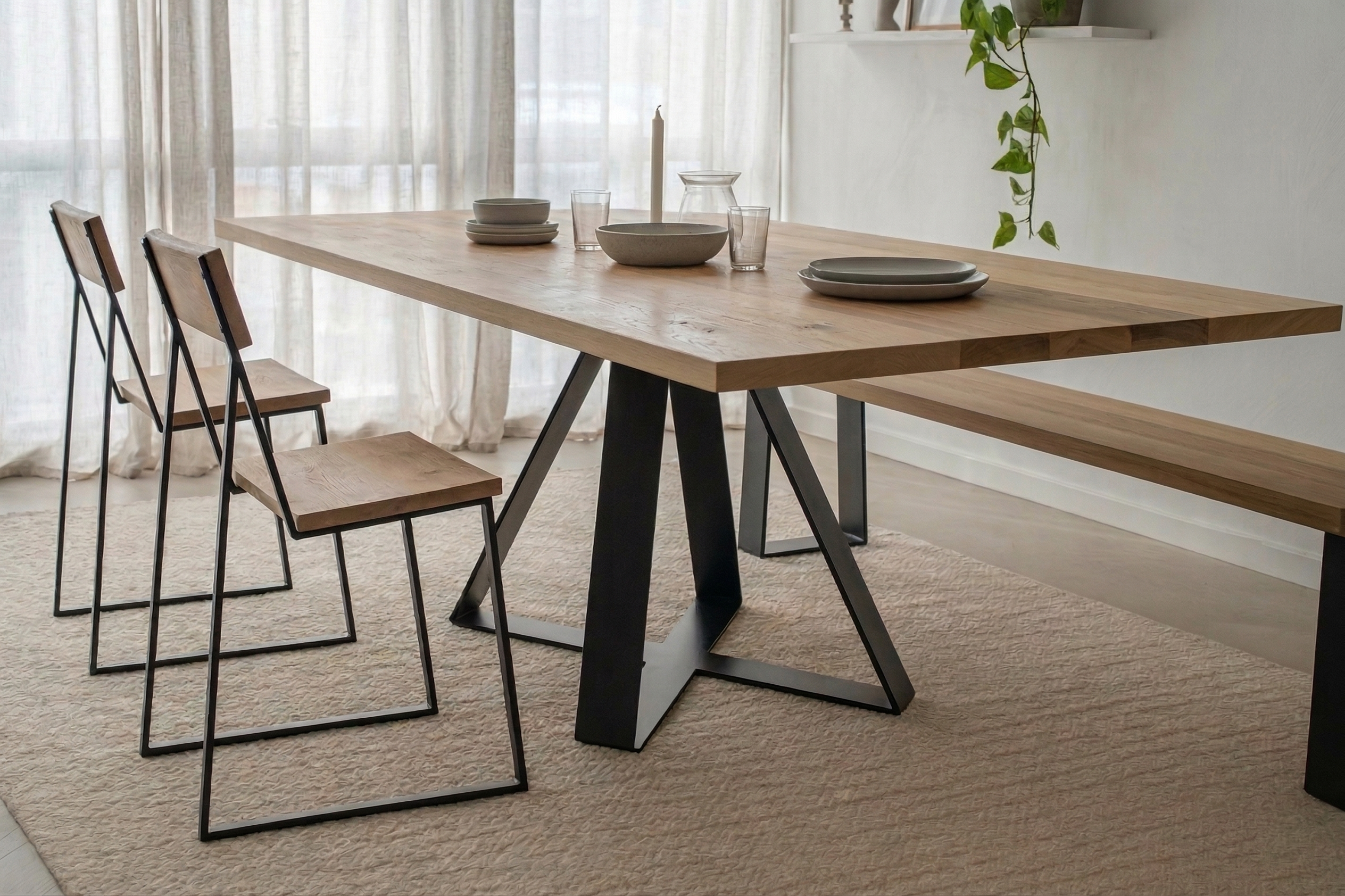 Crossroads dining table in solid Northland Totara on angled steel centre-frame, Christchurch-made