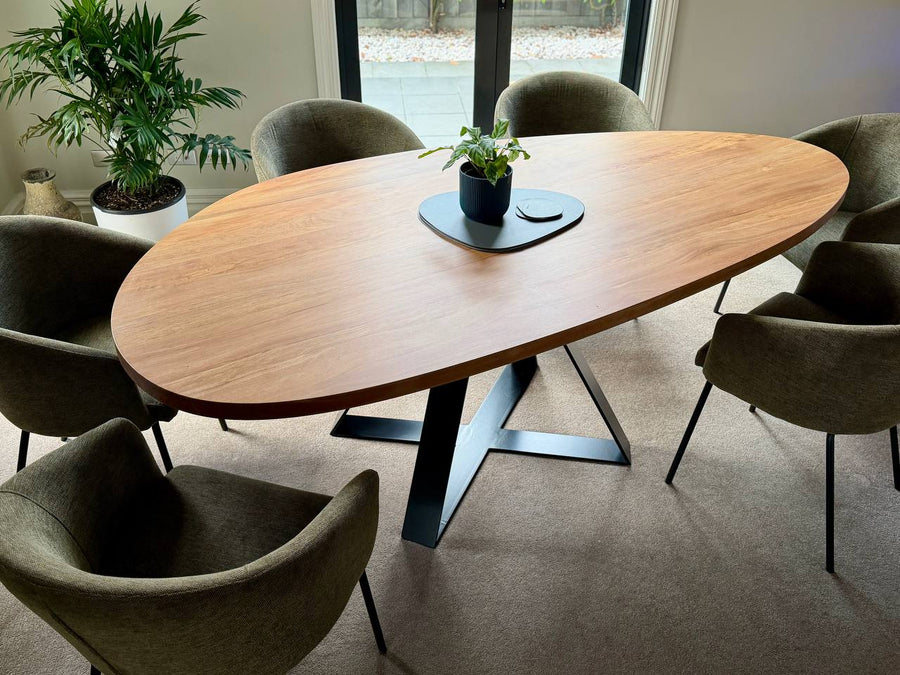 Pebble Crossroads dining table in cyclone-salvaged West Coast Rimu with clear finish and black Crossroads base