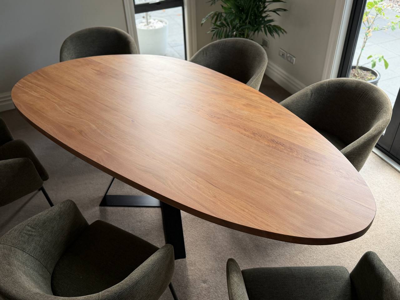Pebble Crossroads dining table showing rounded timber top in cyclone-salvaged West Coast Rimu with clear finish