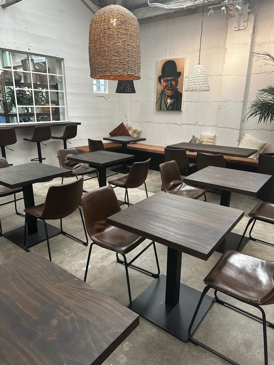 Darkwash timber table tops in a hospitality setting at The Welder
