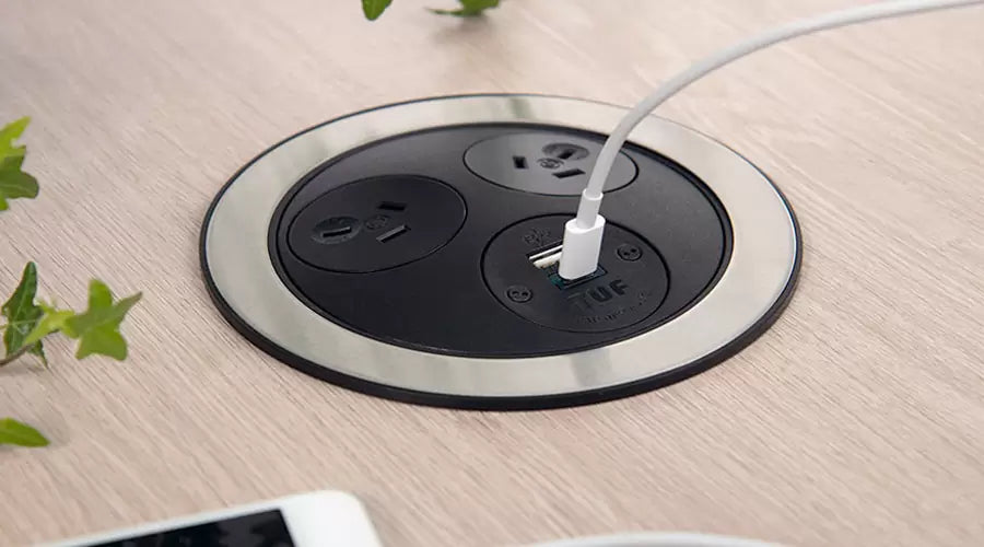 Flush stainless power module close-up in timber surface
