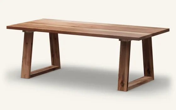 Render of a rectangular Beech dining table, Natural finish, on the Foothill base in solid timber